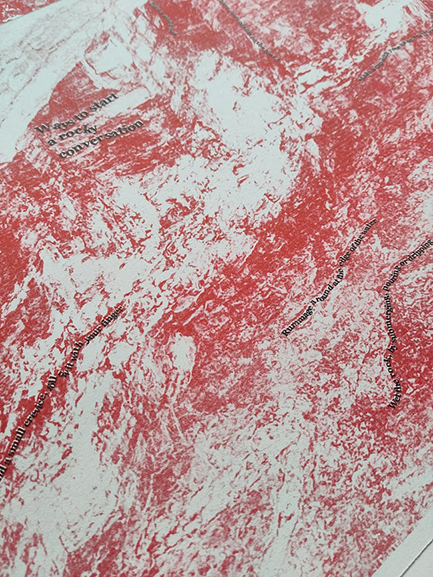A red riso print of rock texture with words meandering along the rock in black saying 'Ways to start a rocky conversation' and 'rummage a round at the edge of teh water'