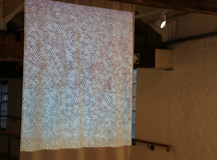 A projected image of a grey textile