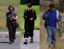 Three people walking in countryside while looking at GPS devices